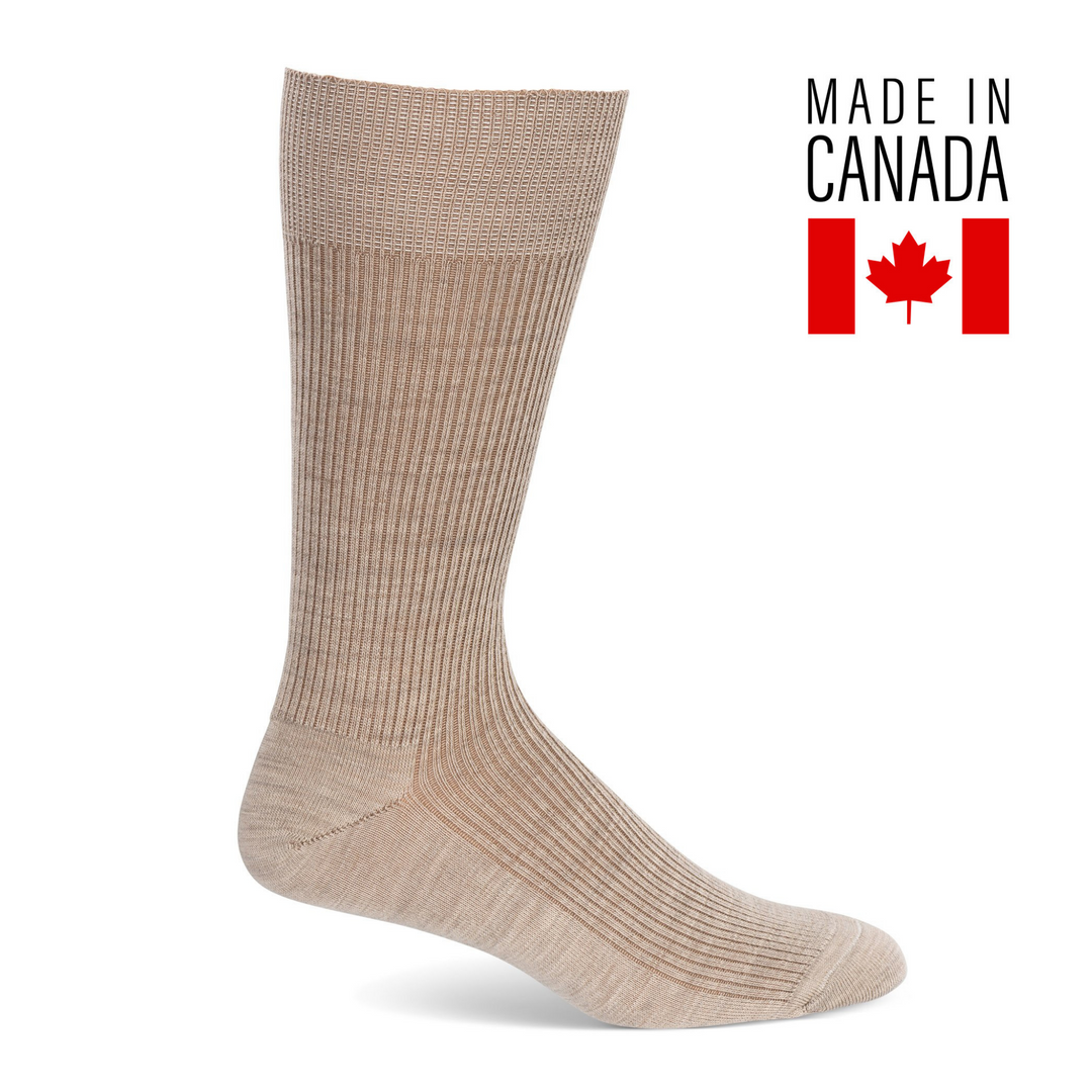 A pair of beige men's merino wool ribbed dress socks with the text 'Made in Canada' and a Canadian flag symbol.